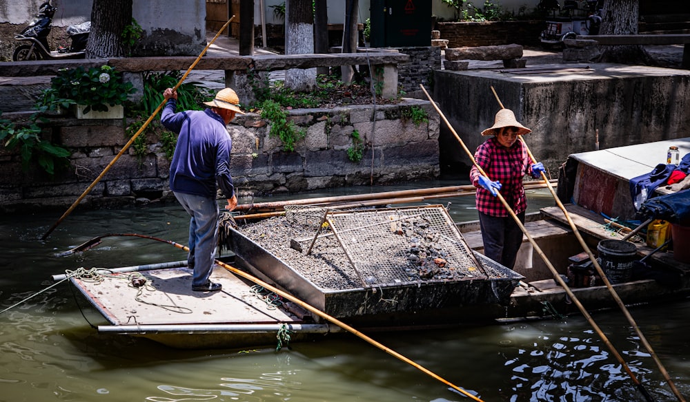 a man and a woman standing on a boat in the water