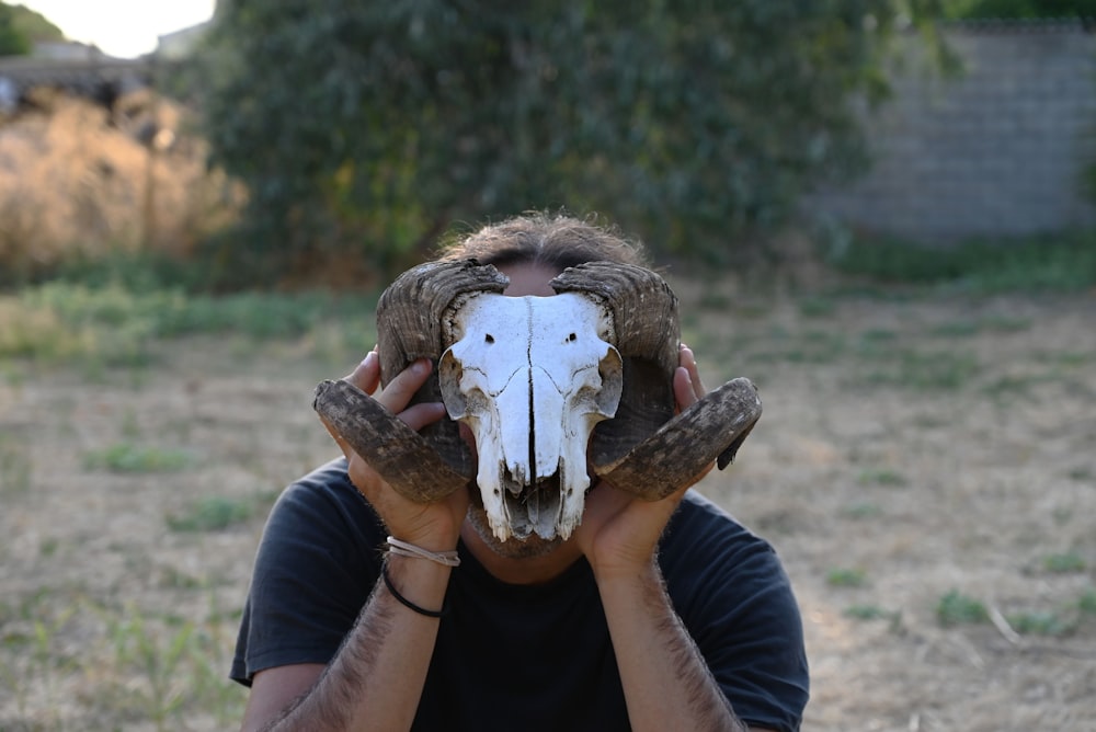 a man with a goat skull mask covering his face