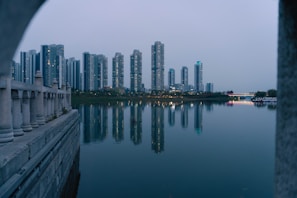Modern skyscrapers reflecting in the waters of Shenzhen’s tech district at dusk