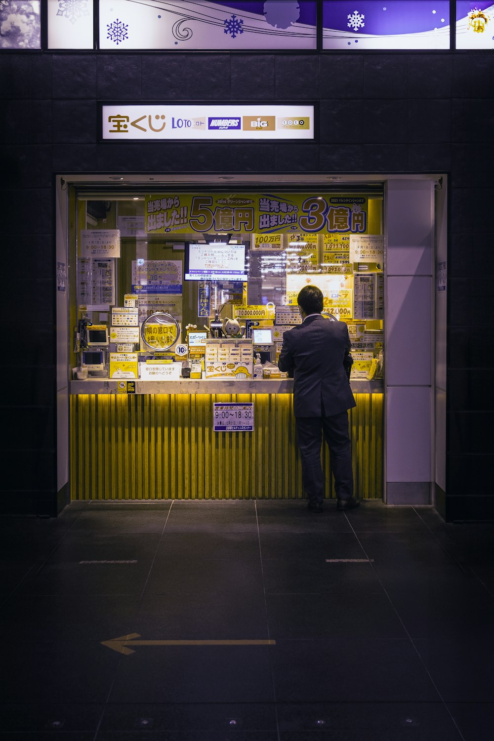 a man standing in front of a store front