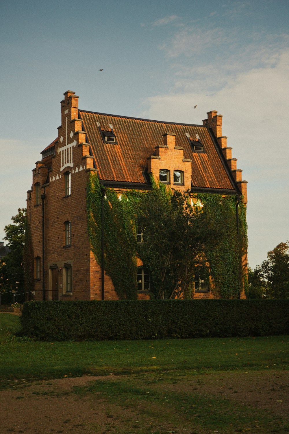 a large brick building with ivy growing on it's side