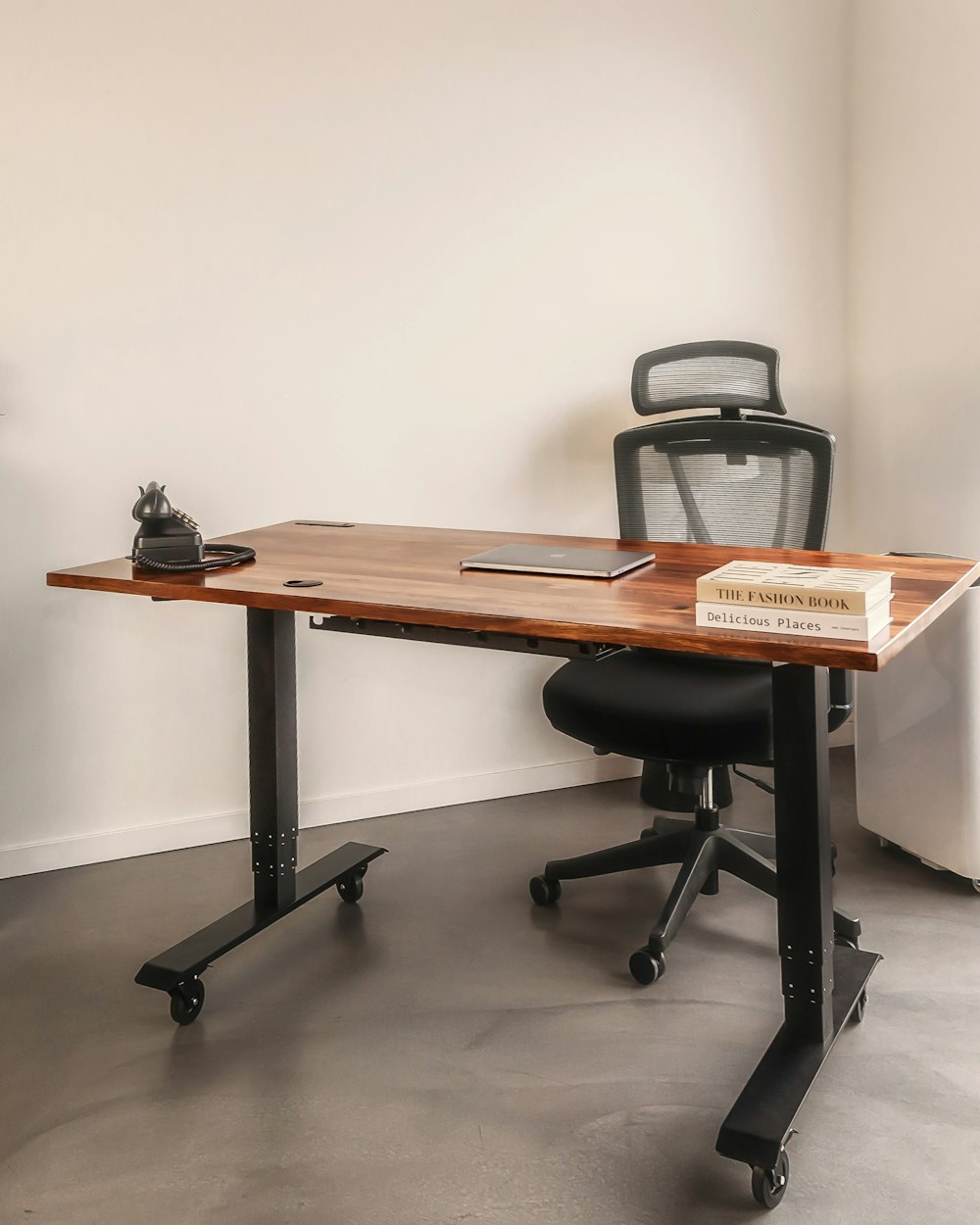 a desk with a laptop and a book on it