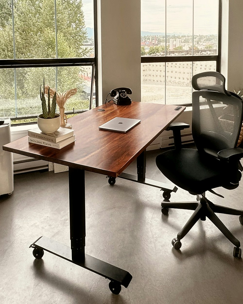 a desk with a laptop on it in an office