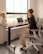 A thoughtful man sitting at a minimalist desk, looking inspired and focused.