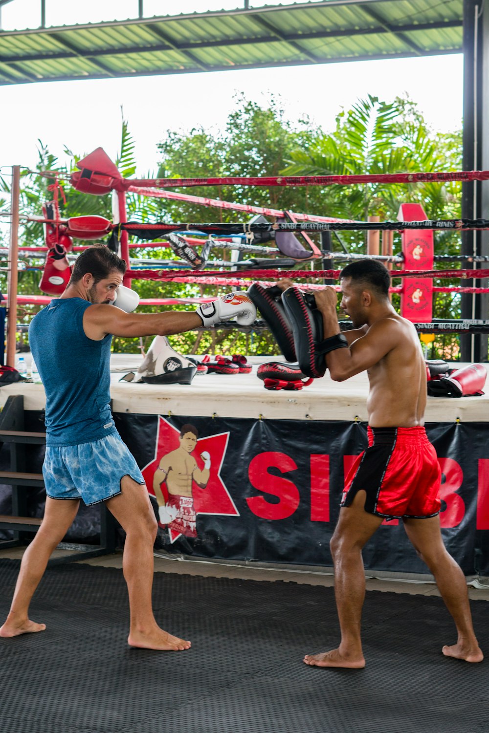 a couple of men standing next to each other in a boxing ring