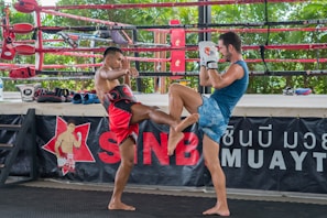 a couple of men standing next to each other in a boxing ring