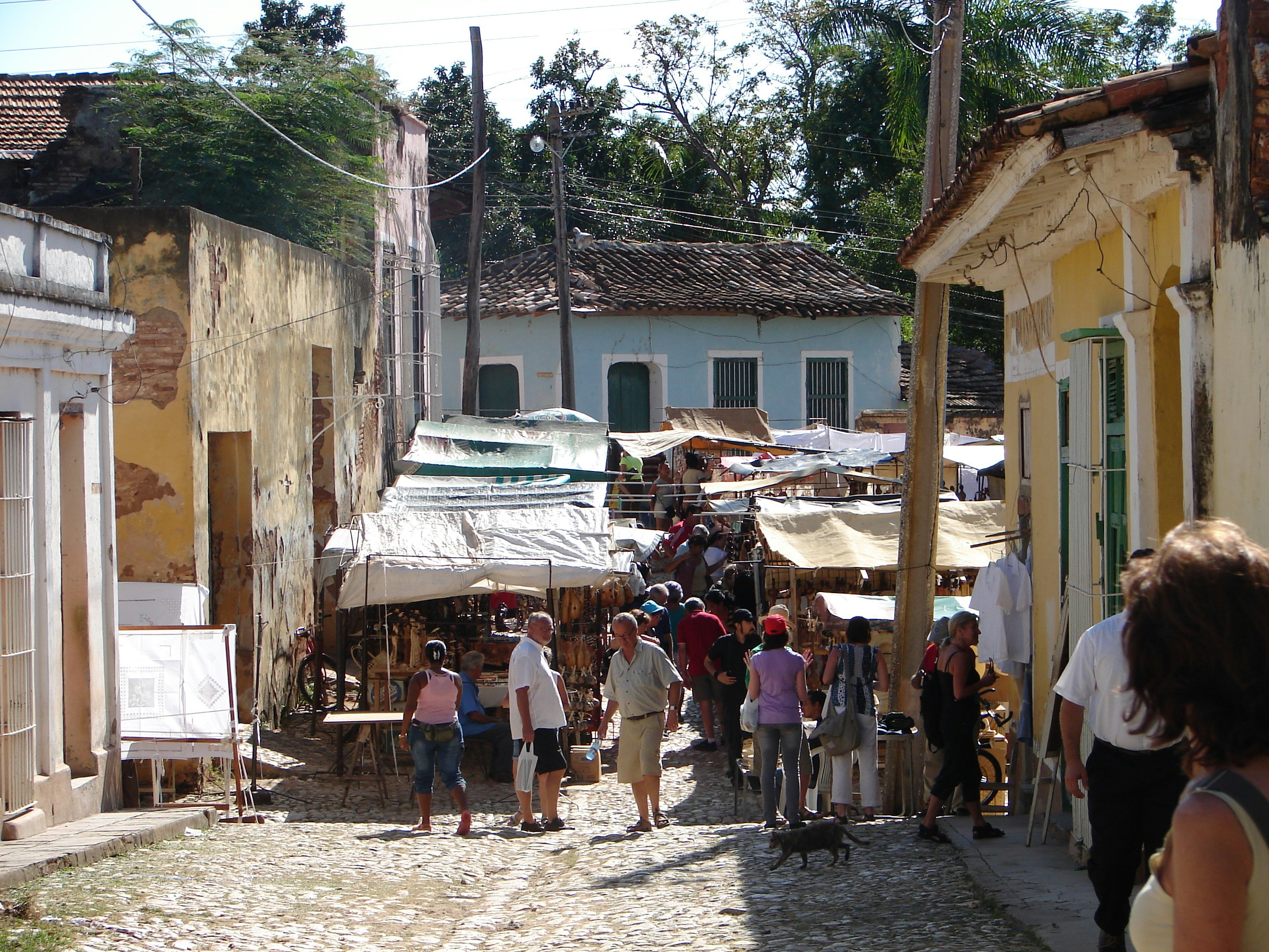 a group of people walking down a street next to buildings