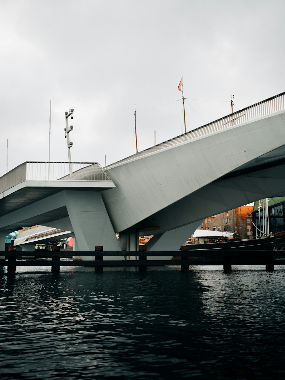 a bridge over a body of water on a cloudy day