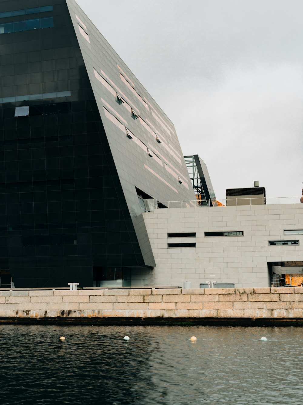 a large building sitting next to a body of water