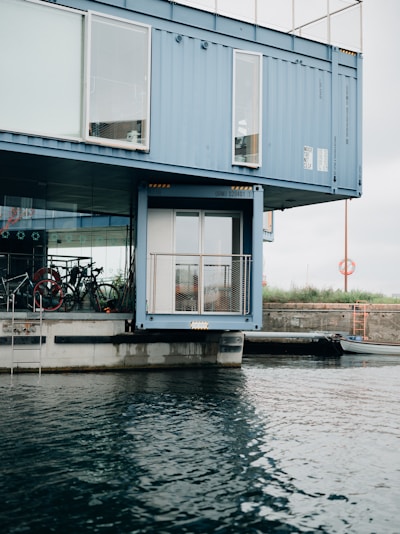 A modern container home set against a scenic backdrop.