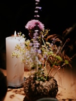 a candle and some flowers on a table