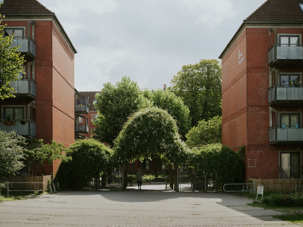 an empty parking lot in front of two brick buildings