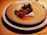 A rustic seafood dish beautifully plated on a wooden table.