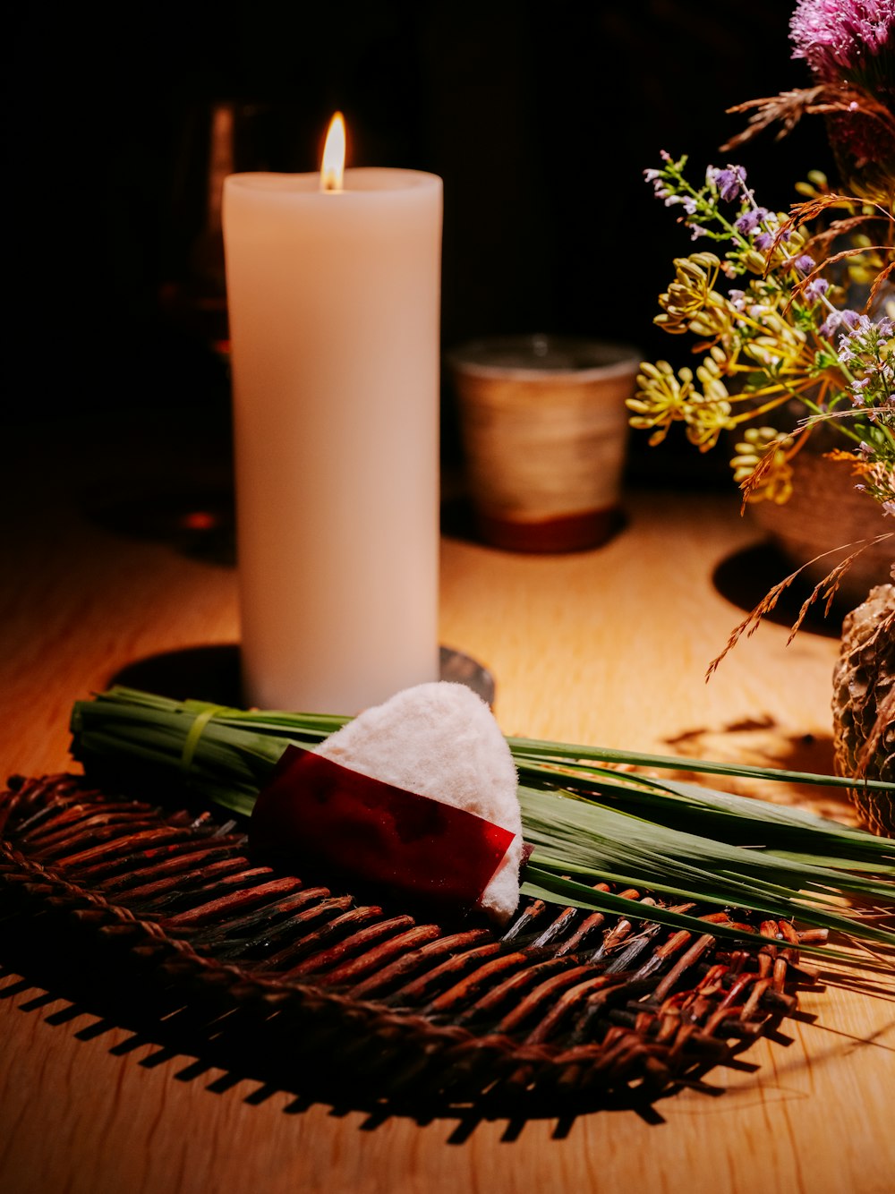 a candle and some flowers on a table