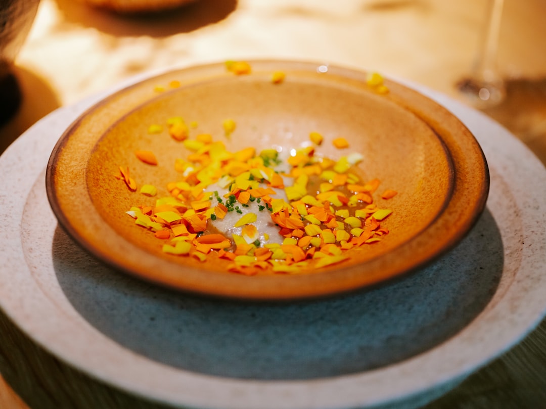 a plate with a small bowl of confetti on top of it,