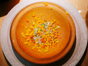 a bowl filled with a lot of food on top of a table