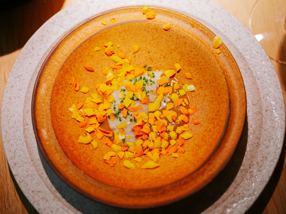 a bowl filled with a lot of food on top of a table