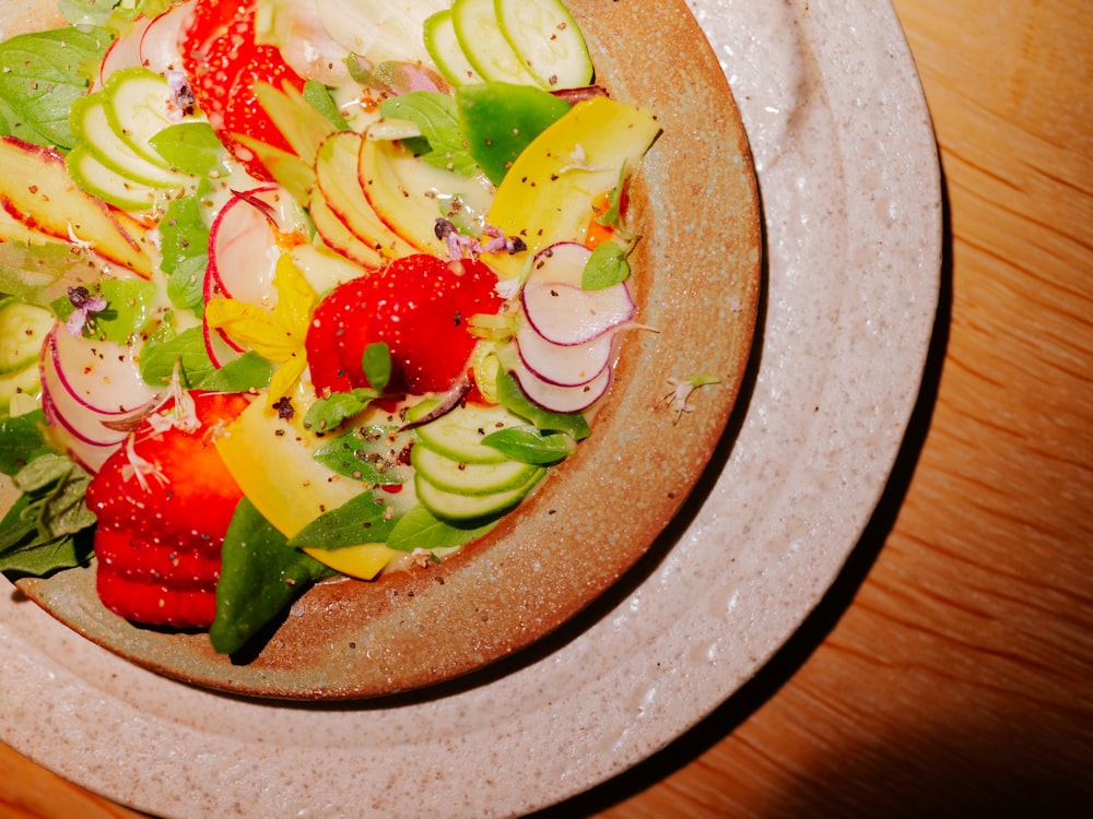 a plate of fruit salad on a wooden table