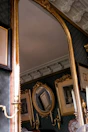 Soft gold accents on the room’s light fixtures and mirror frame.