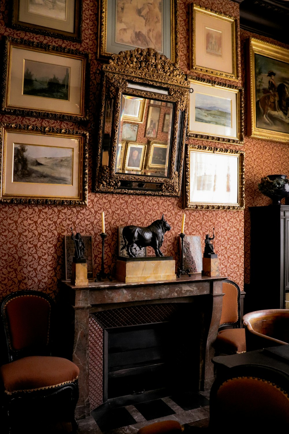 a living room with a fireplace and pictures on the wall