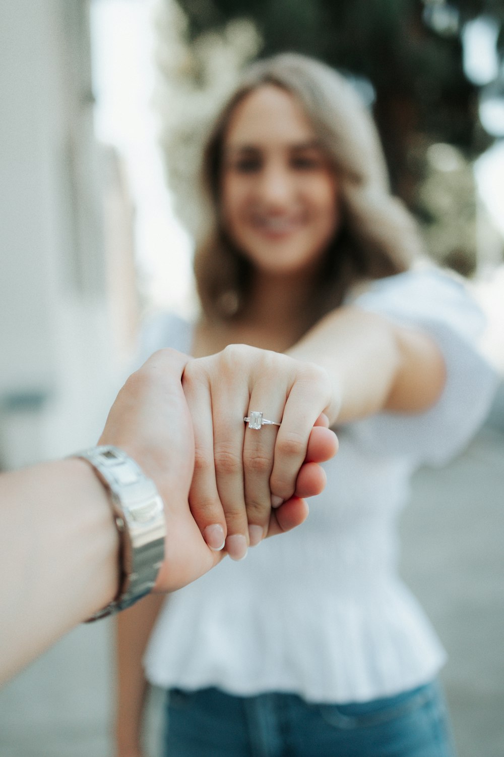 a close up of a person holding the hand of another person