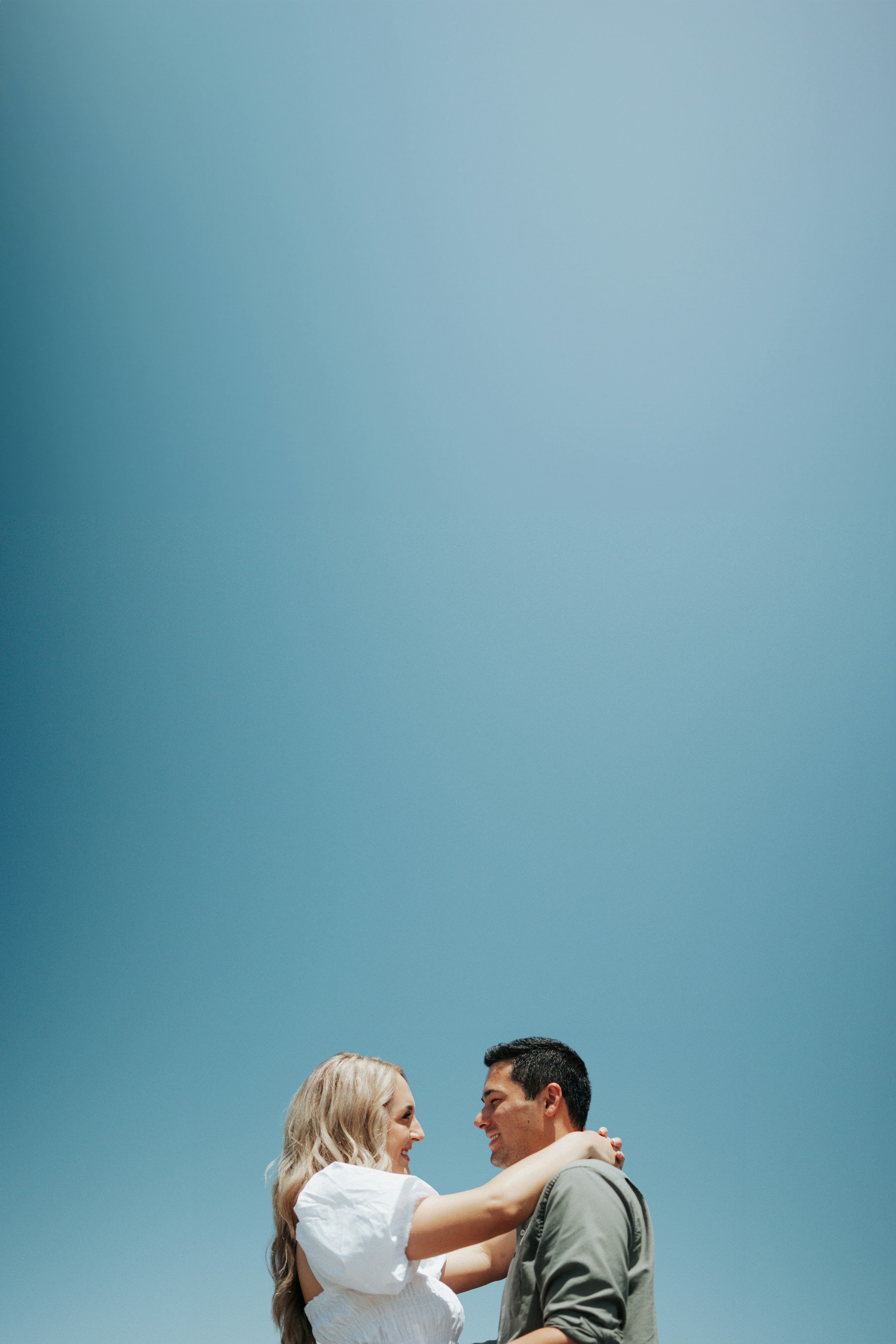 a man holding a woman on the beach