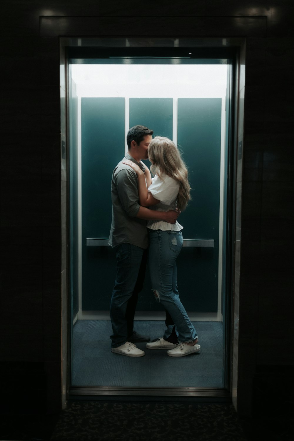 a man and a woman standing in an elevator
