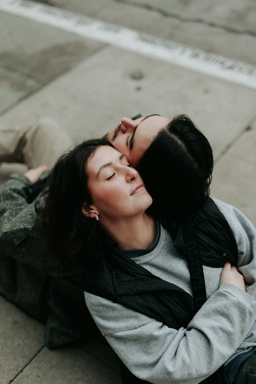 a couple of people that are laying on the ground