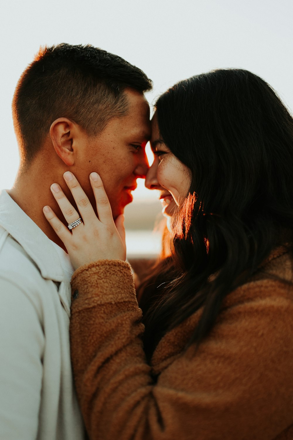 a man and a woman standing close to each other