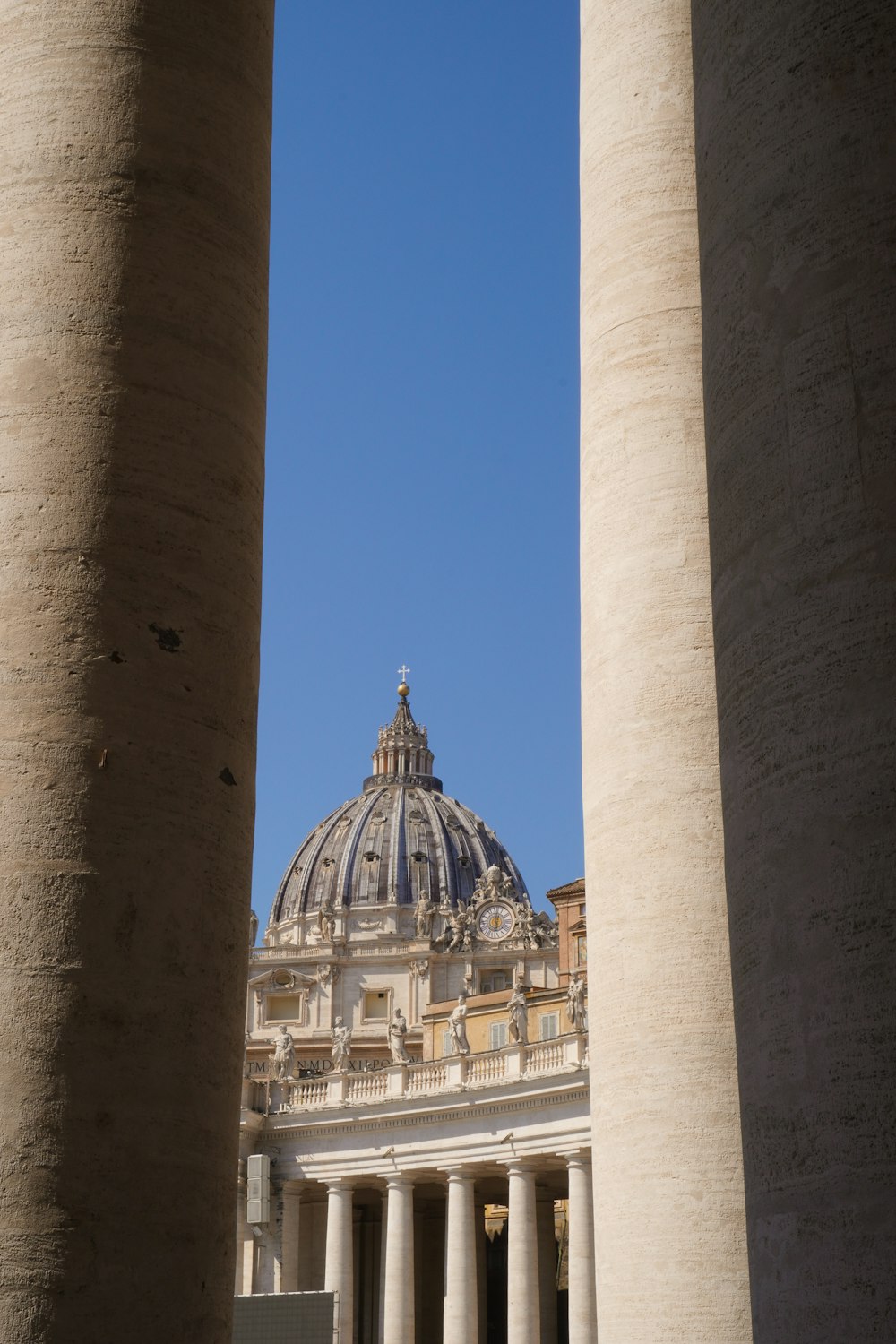 the dome of a building is seen through two pillars