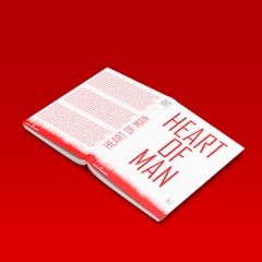 A book titled 'Heart of Man' is open, revealing text inside. The cover and the pages have a red and white color scheme. The book is placed against a bright red background that matches the red on the book.