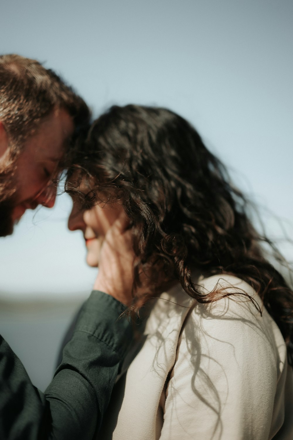 a man and a woman standing close to each other