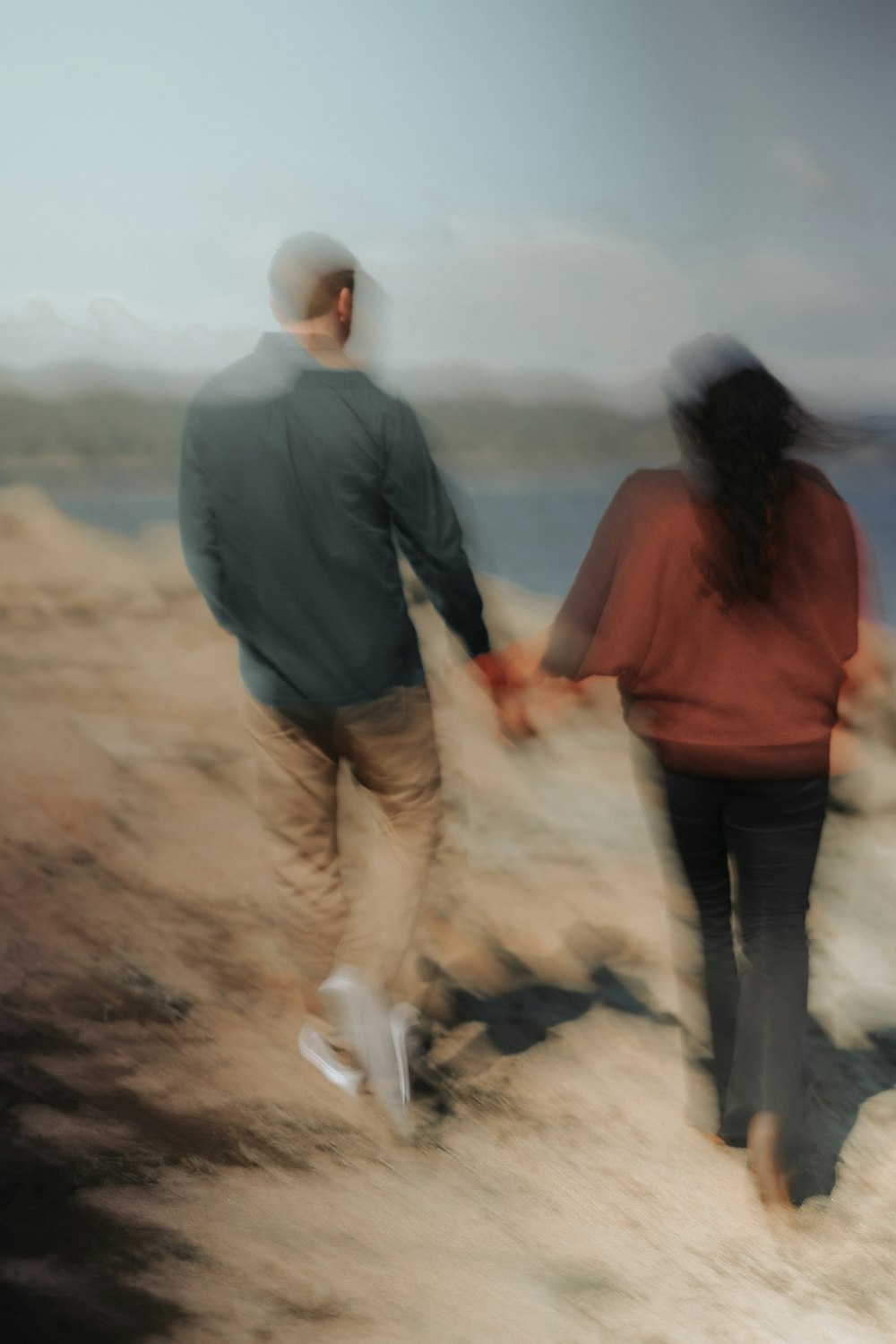 a blurry photo of a man and a woman holding hands