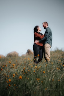 A couple sharing a tender moment in a field of wildflowers.