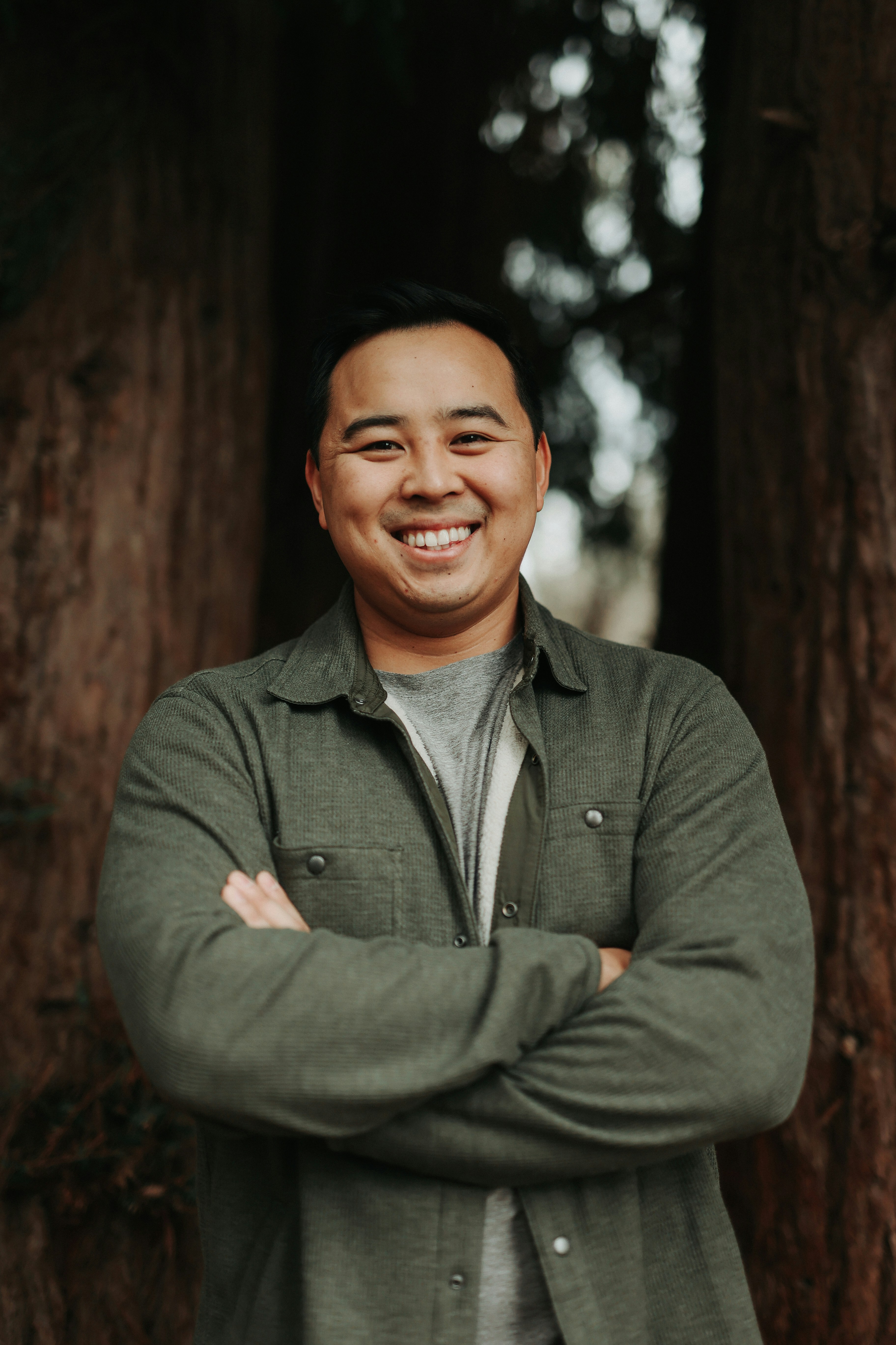 a man standing in front of a group of trees