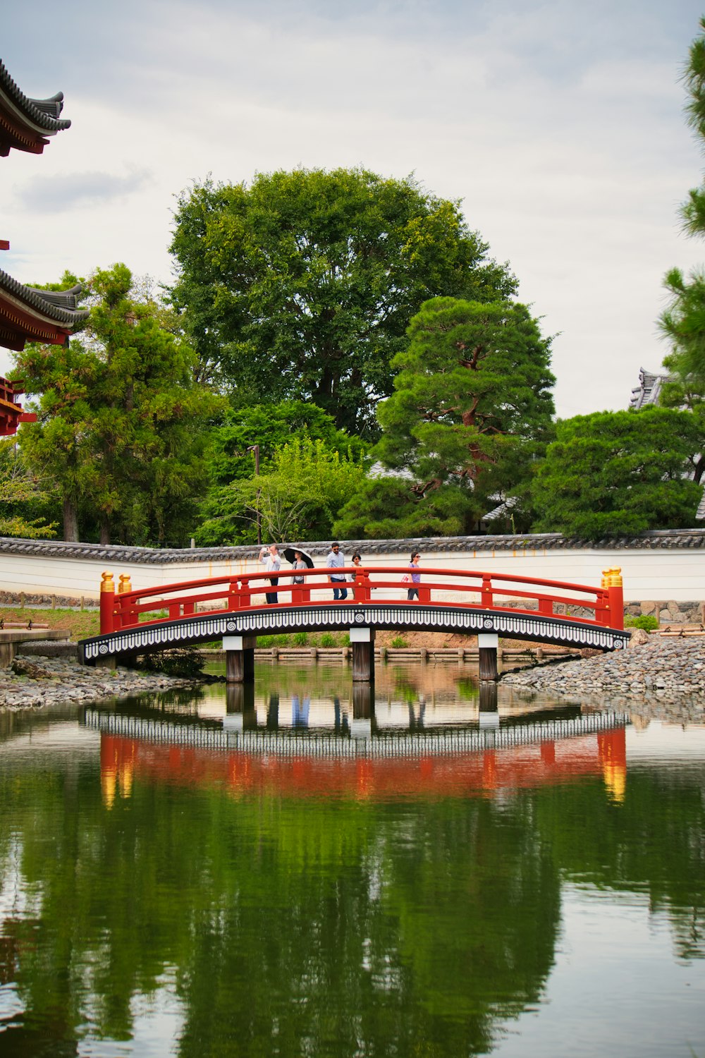 a red bridge over a body of water