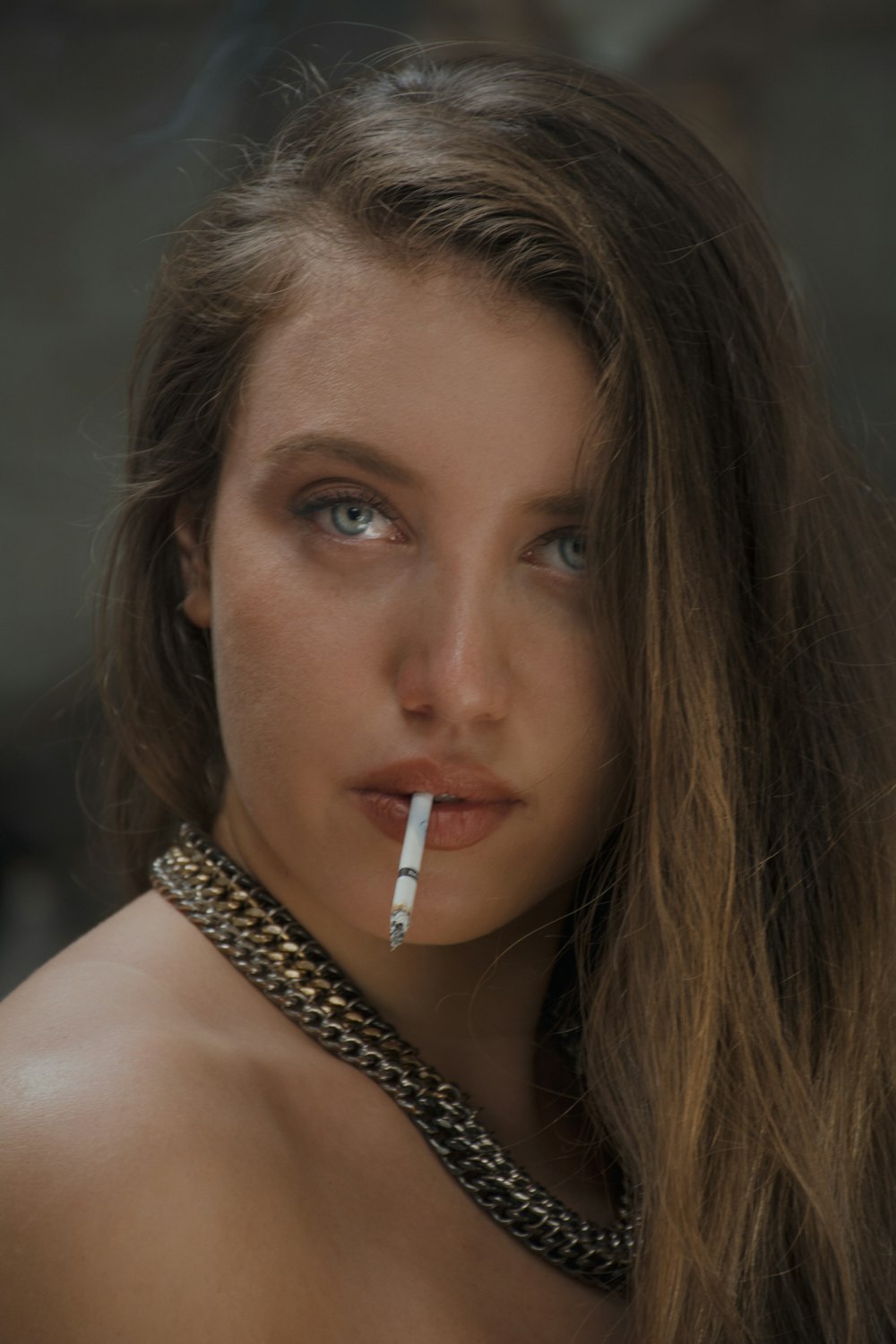 a woman with a cigarette in her mouth