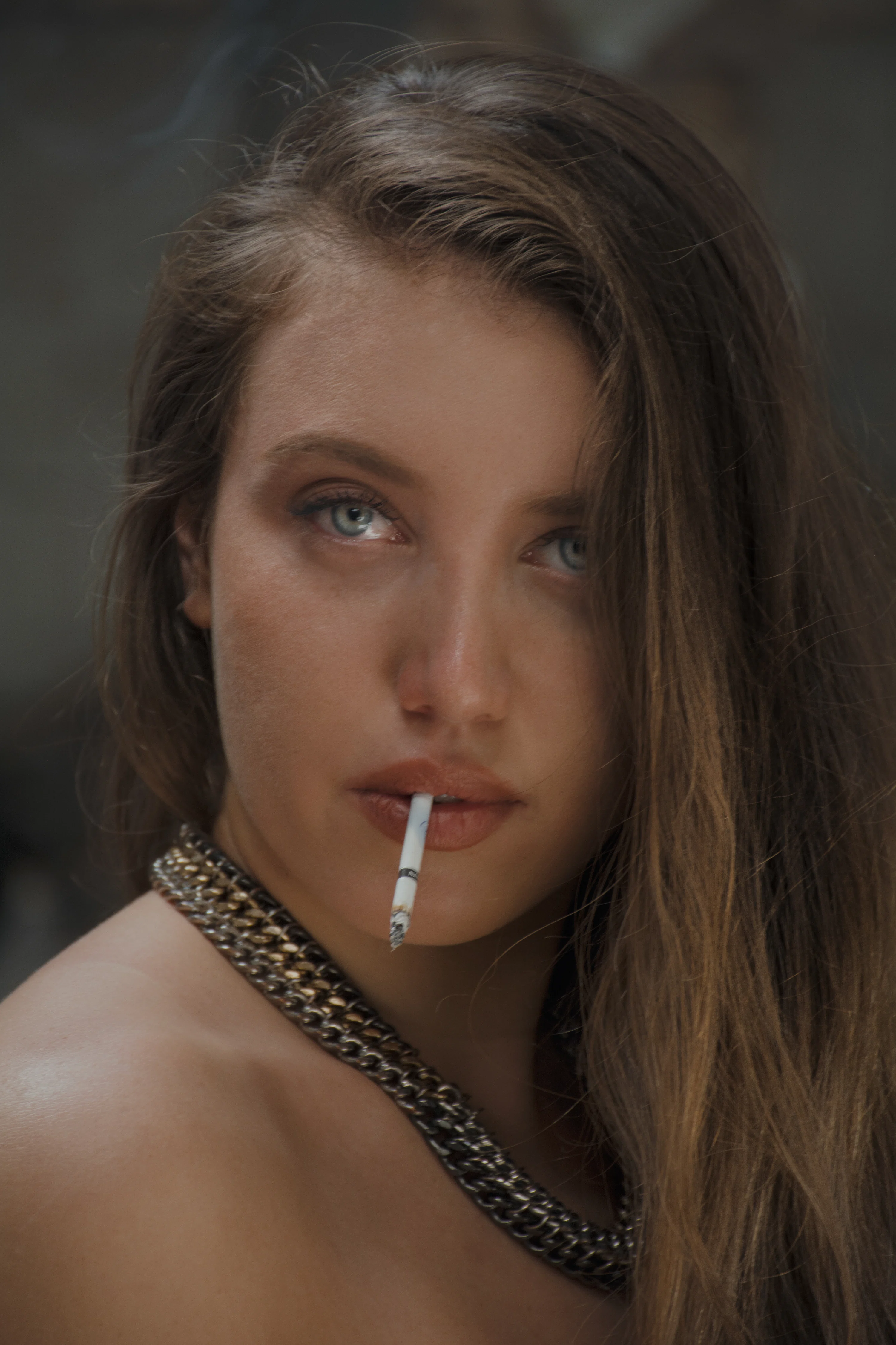 cigarette between her lips JARED KINLEY A woman with a cigarette