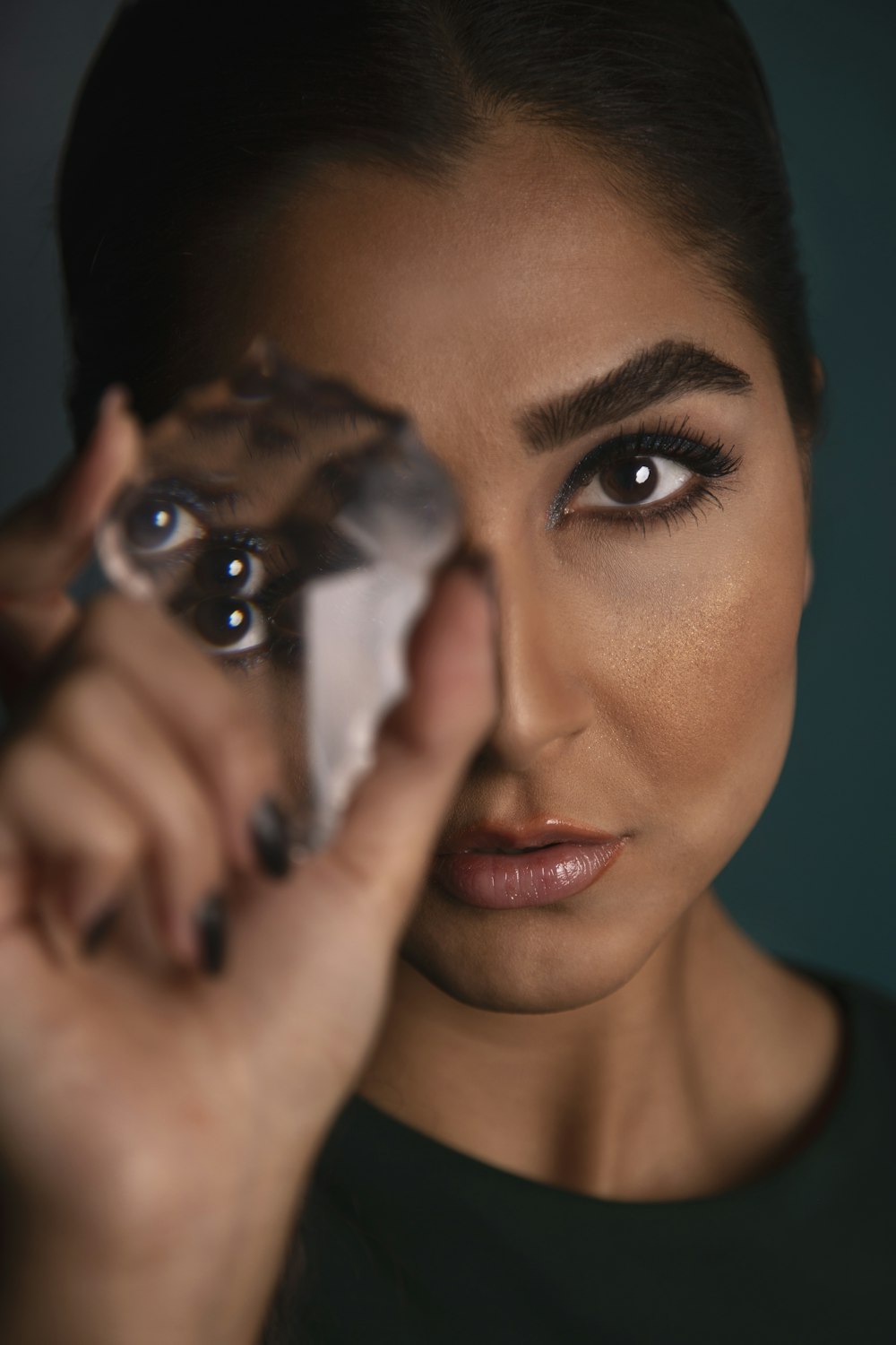 a woman holding up a piece of tin foil to her eye