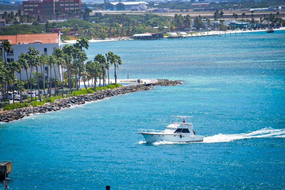 a white boat traveling down a body of water