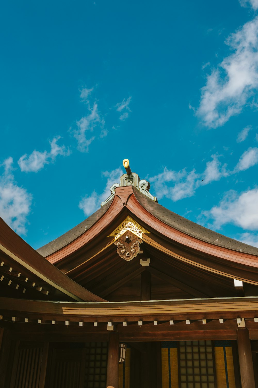 a man standing in front of a building under a blue sky