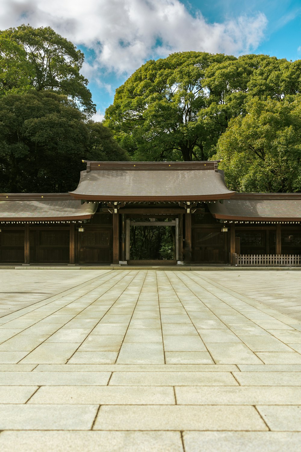 an empty courtyard with a building in the background