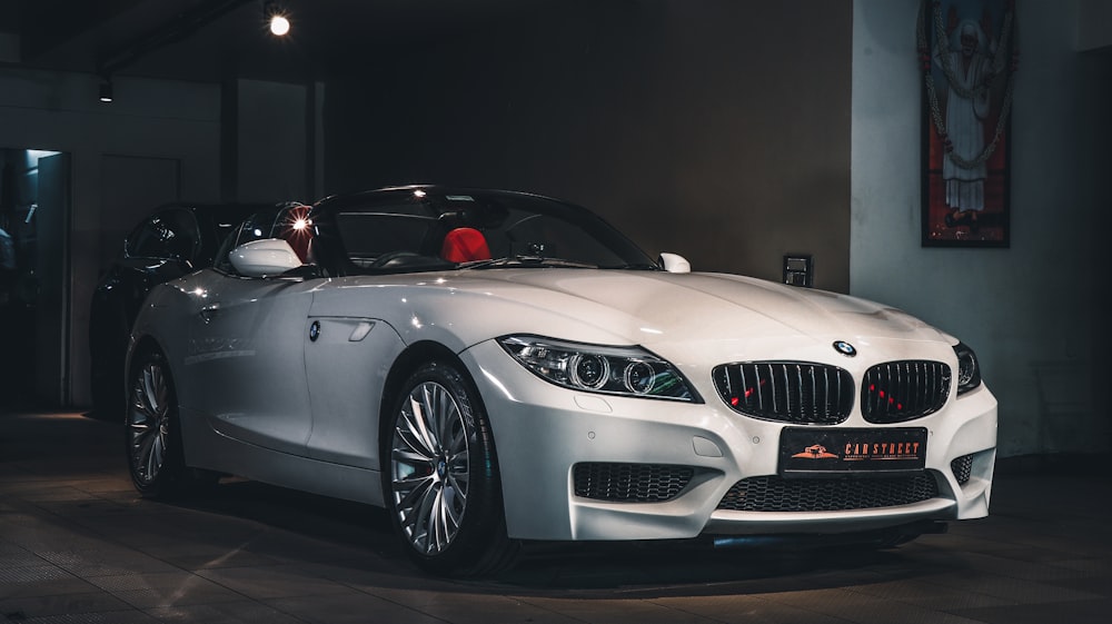 a white sports car parked in a garage