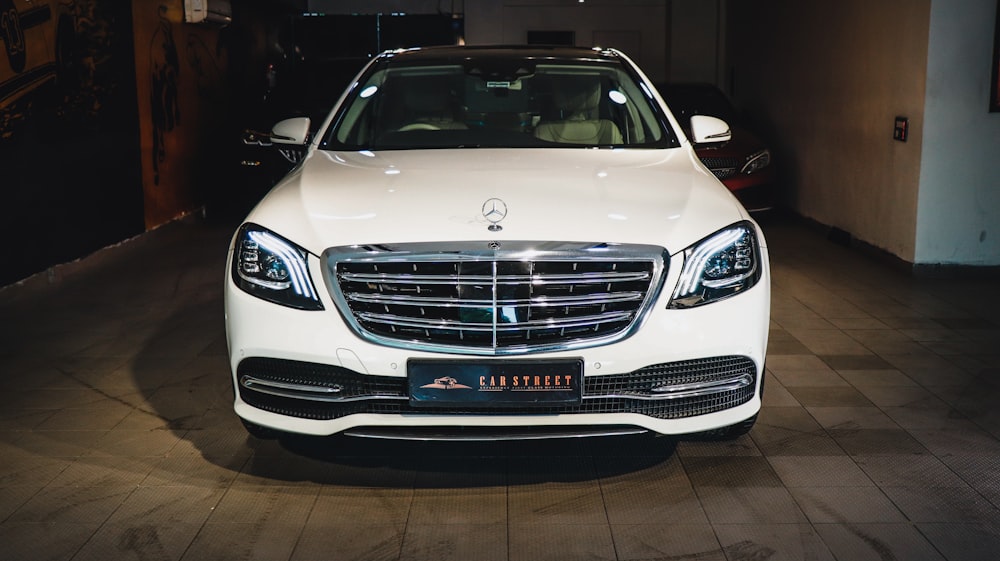 a white car is parked in a garage