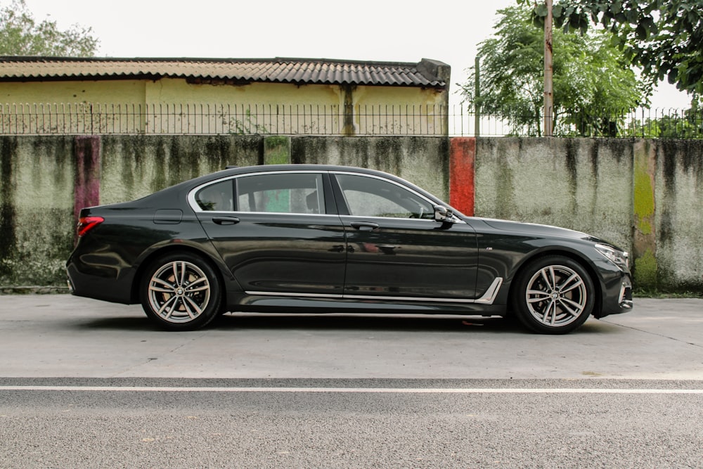 a black car parked in front of a building