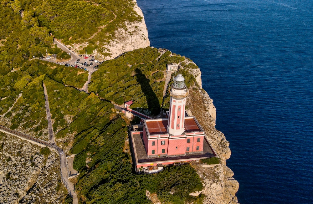 an aerial view of a lighthouse near the ocean