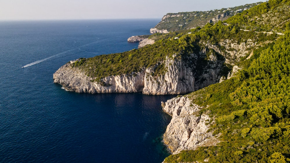 an aerial view of a boat on a body of water