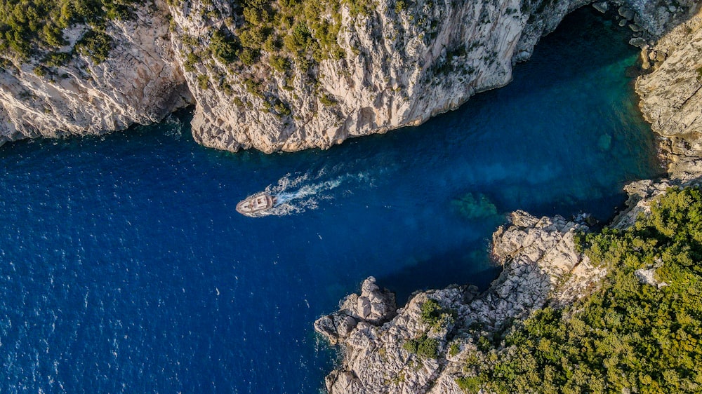 an aerial view of a body of water surrounded by cliffs