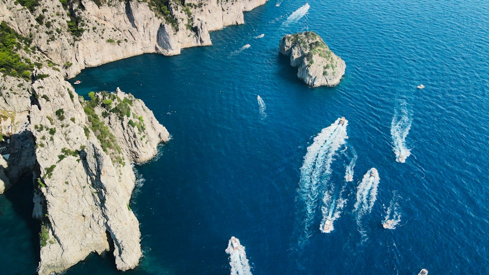 a group of boats floating on top of a body of water