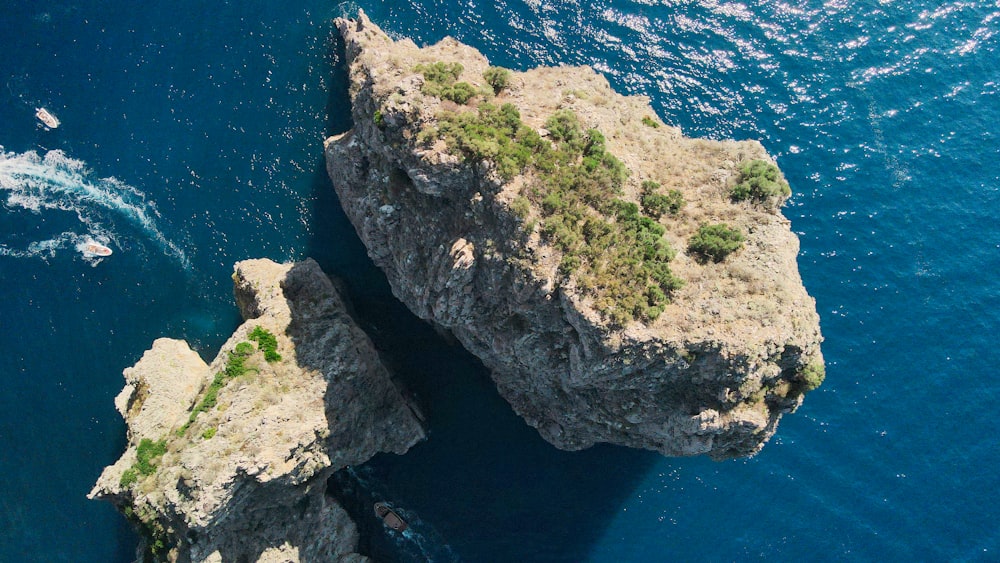 a rock formation in the middle of a body of water